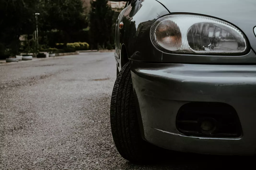 Compact hatchback parked in soft evening light along a quiet suburban street